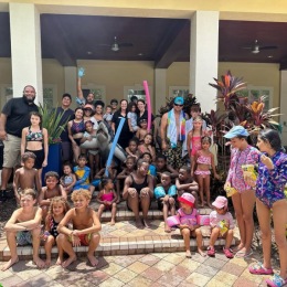 Welcome Home lots of people celebrating poolside