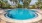 a pool with trees around it