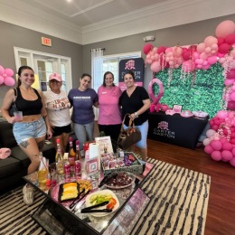 Welcome Home women wearing pink and celebrating