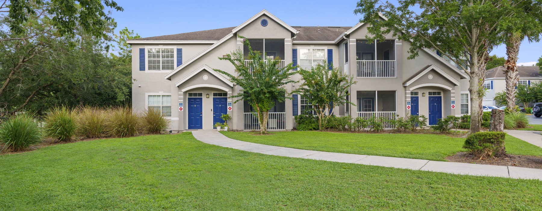 outside of apartment with walking path and trees